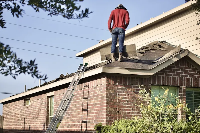 Professional roofer working on a residential roof in Downtown Corona